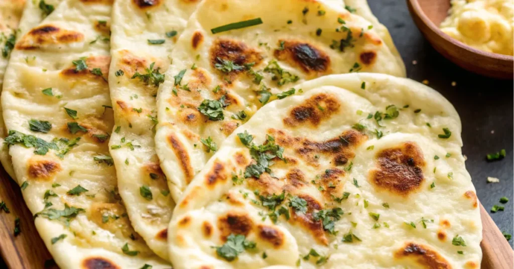 Fresh garlic naan bread recipe served hot with butter and herbs