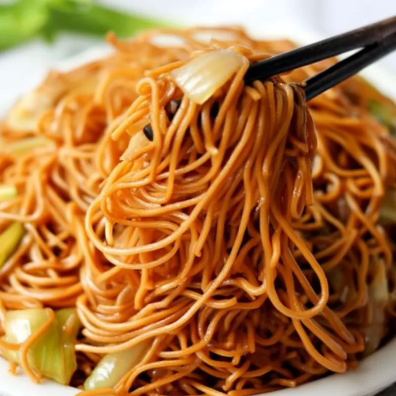 panda-express-chow-mein Panda Express Chow Mein served on a plate with chopsticks lifting noodles
